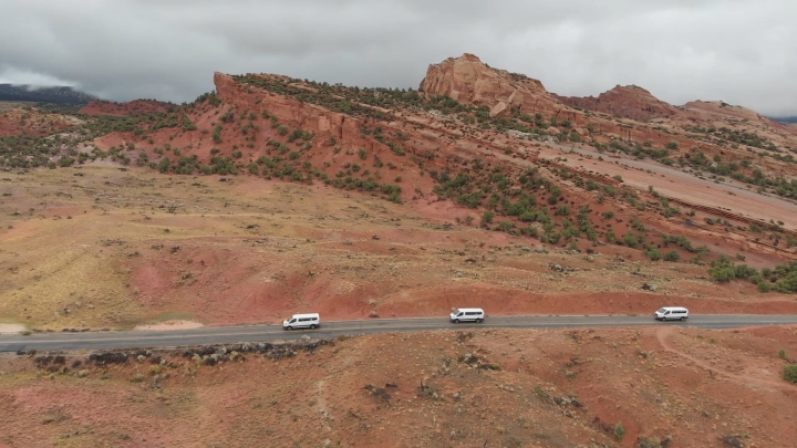 A convoy of vans on a geological tour of the American West