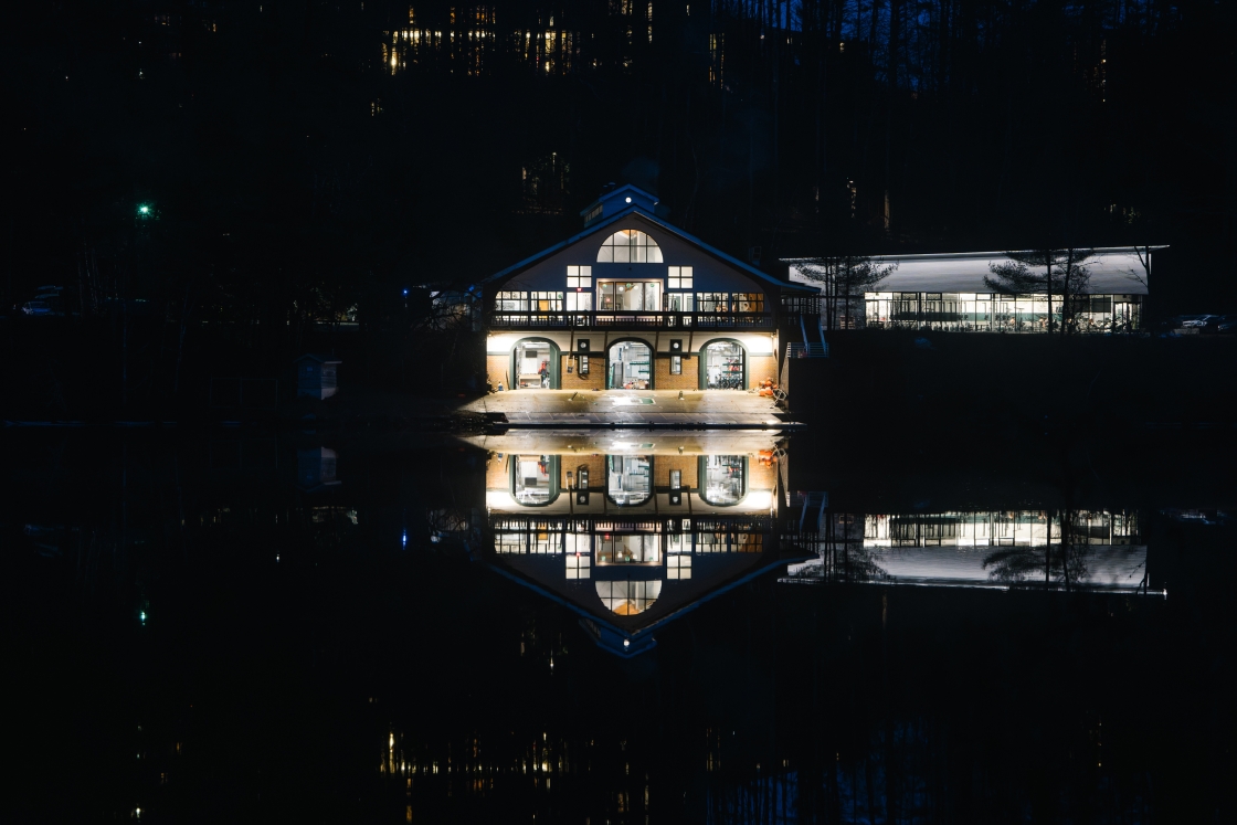 The Rowing Boathouse lights reflected in the rive