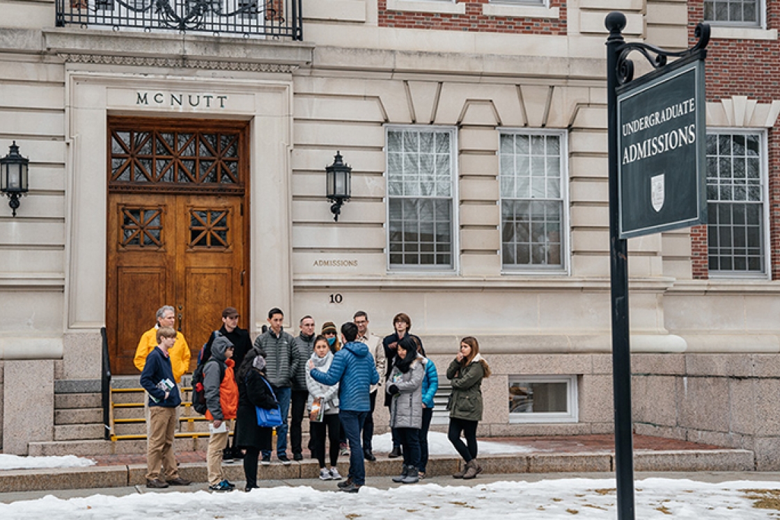 a group of prospective students gathered outside the admissions building at the start of a tour