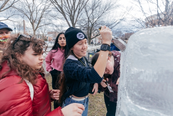 Students carving an ice sculpture