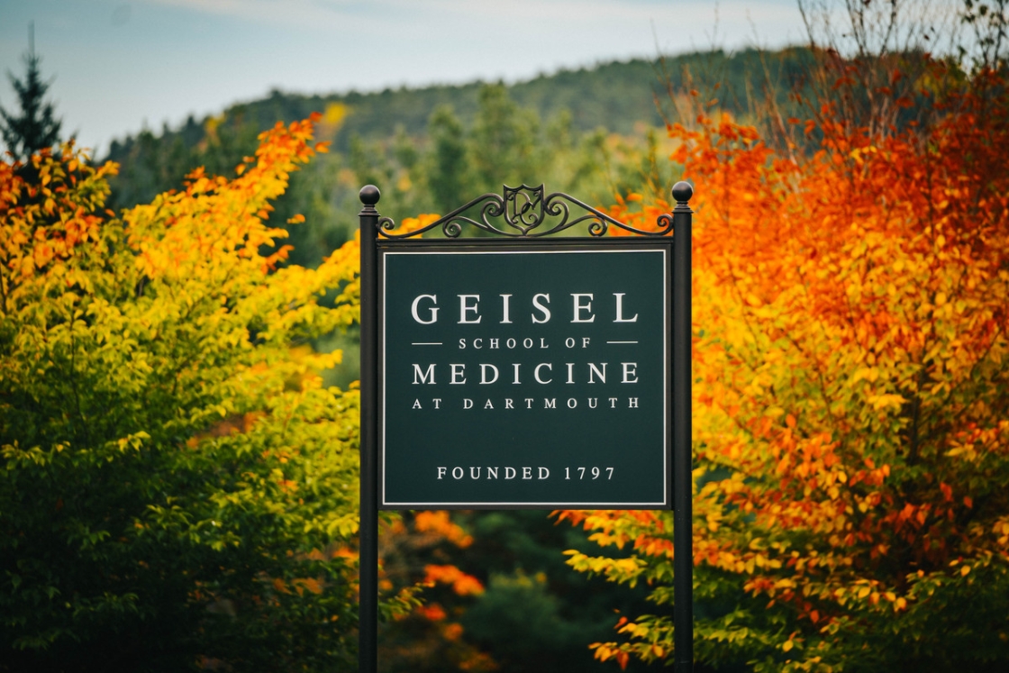Geisel school of medicine sign with bright foliage in the background