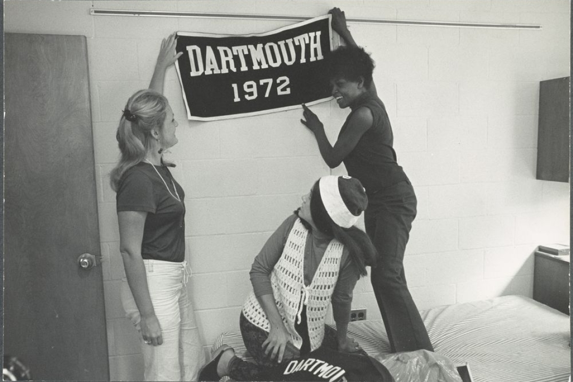 Three women hanging a Dartmouth 1972 banner