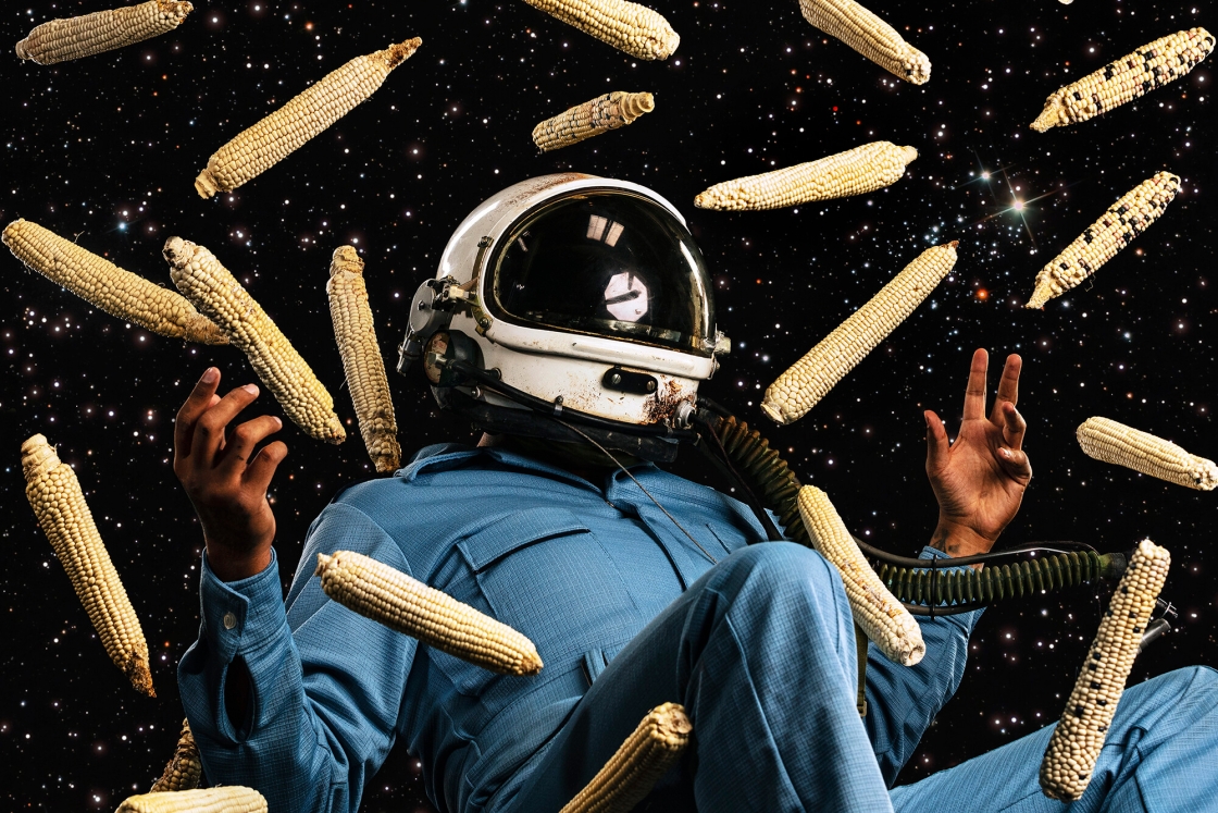 Floating astronaut surrounded by corn cobs