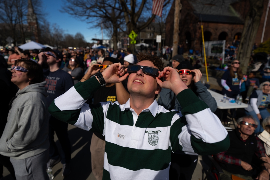 Dartmouth student looks at the eclipse