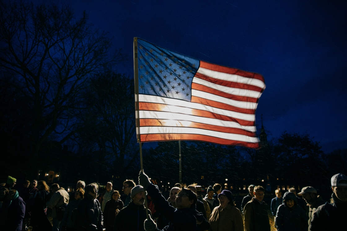 U.S. flag lit from behind during Veteran's Retreat Ceremony