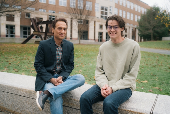 Alireza Soltani, associate professor of psychological and brain sciences, and Ethan Trepka '22 sit on a wall together