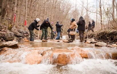 Students doing a lab in a running brook
