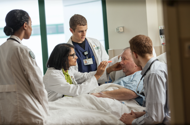 Attending DHMC patient Corey Raymond are, from left, Salma Dali '19, a medical student; Roshini Pinto-Powell, a professor of medicine and associate dean for admissions at Geisel; Alec Fisher '19, a medical student; and Griffin Reed '20, a medical student.