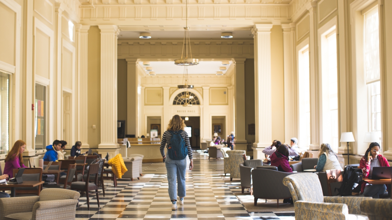 Students walking and studying in Reiss Hall in Baker Library
